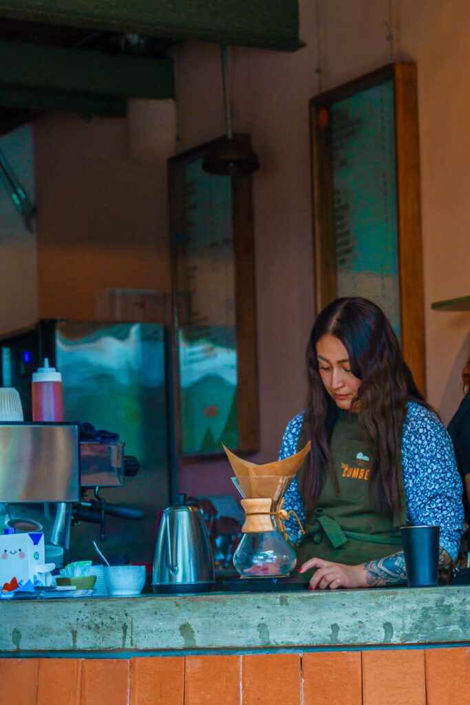 A barista preparing drip speciality coffee in Mexico City at CUMBE.