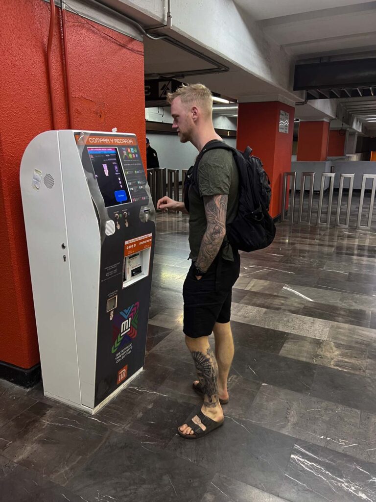 Blogger Robinek buying a metro ticket in Mexico City.