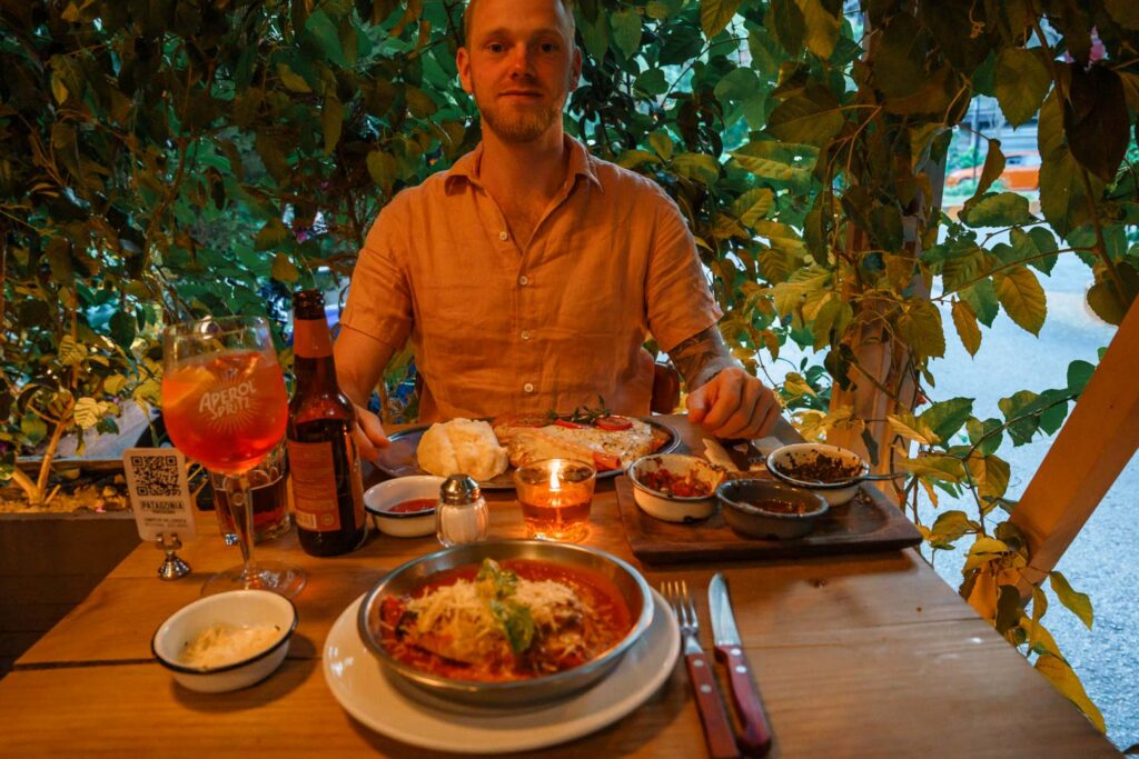 Blogger Robin enjoying his homemade chicken dish at Patagonia restaurant