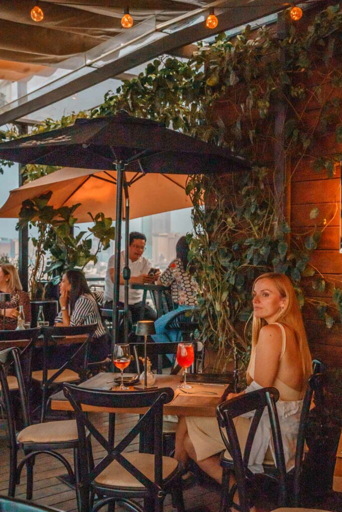 Blogger Mal enjoying a cocktail at Supra Roma Rooftop Bar